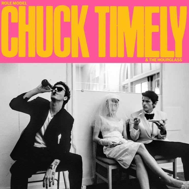 Black and white album cover featuring three people in unusual attire.