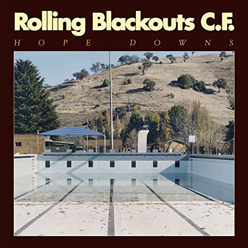 Album cover for Rolling Blackouts C.F. “Hope Downs” featuring a rural landscape.