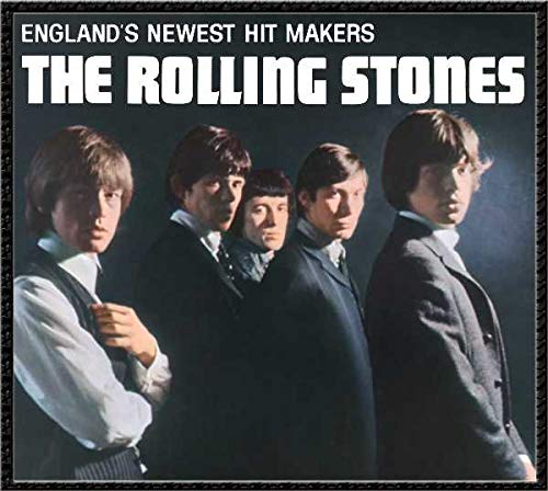 The Rolling Stones album cover featuring five band members in suits against dark background.