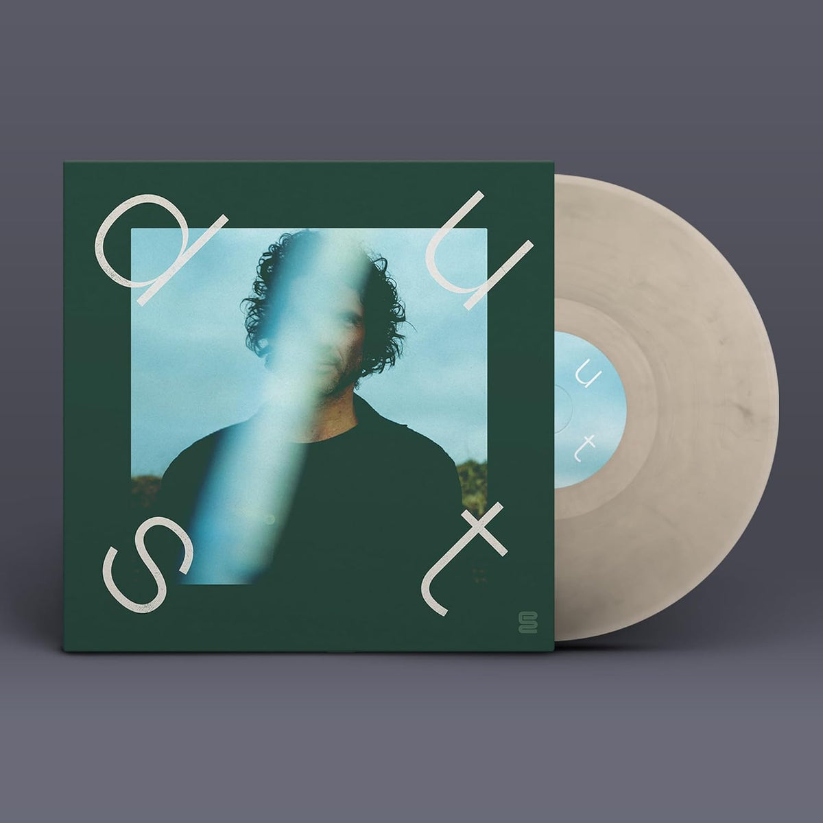 Vinyl record with green cover featuring a portrait and white lettering.