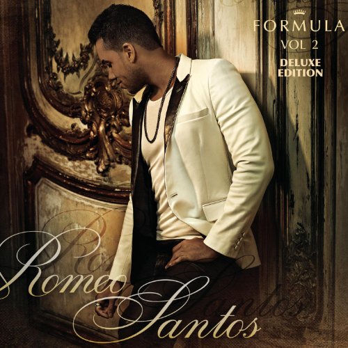 Romeo Santos wearing a white blazer, leaning against an ornate wooden door.