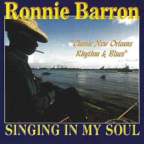 CD cover: profile of a man with a hat, waterfront background.
