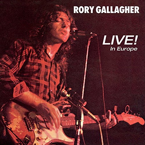 Rory Gallagher playing electric guitar on stage, bathed in red lighting, album cover art.