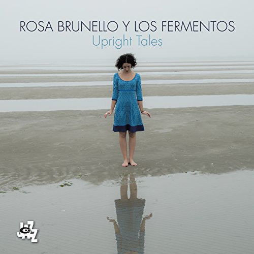 CD cover: woman standing in shallow water on a beach.