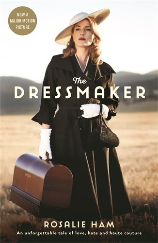 Book cover: woman in black coat with hat, carrying luggage.