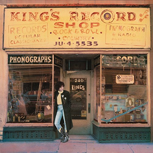 Rosanne Cash album cover featuring a storefront and woman leaning against it.