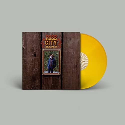 Vinyl record with yellow disc and album cover featuring a portrait.