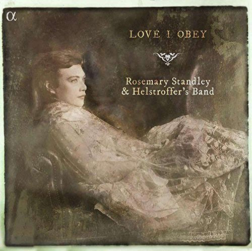 "CD cover featuring a sepia-toned, vintage-style image of a woman in a long, flowing dress."