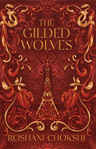 Book cover: “The Gilded Wolves” with gold ornate design and Eiffel Tower.