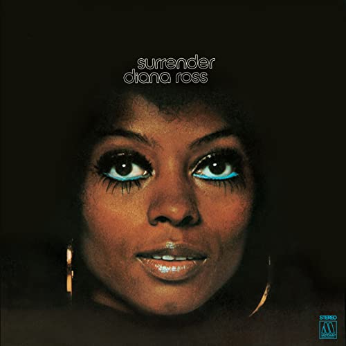 Close-up portrait of Diana Ross with blue eyeliner against a dark background.