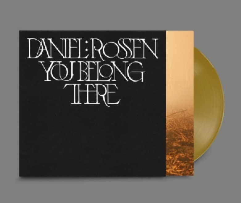 Black vinyl record cover with white text and a golden edge.