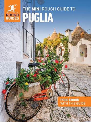 A bicycle with a flower basket parked on a cobblestone street in Puglia.