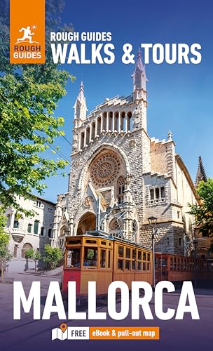 A vintage tram passes a stone church in Mallorca on a travel guide cover.