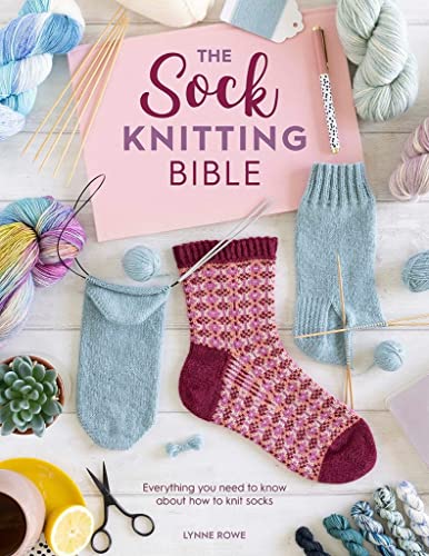 Book on sock knitting surrounded by yarn, needles, and knitted socks.