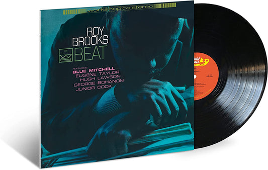 Vinyl record sleeve with a man resting on a drum kit, partially covering a black vinyl.
