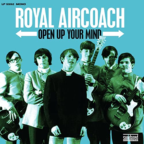 1960s band Royal Aircoach in matching suits with guitars, turquoise background.