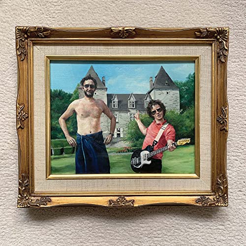 Painting of two men with a castle in the background, framed.