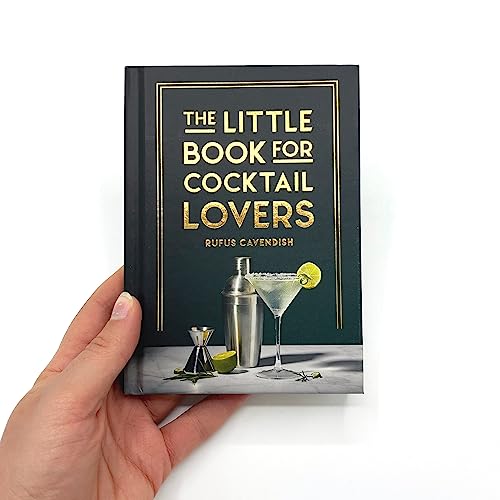 Dark teal book titled "The Little Book for Cocktail Lovers" held in a hand.
