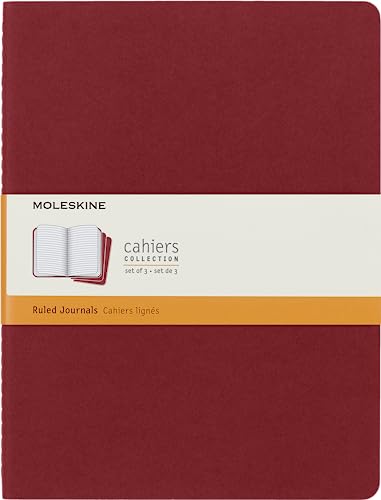 A red Moleskine Cahier journal set with a white and orange paper band.