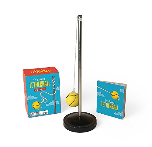 Miniature tetherball game with a yellow ball, pole, and base, in box.
