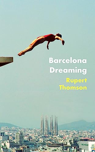 A diver in a red swimsuit leaps above the Barcelona skyline featuring the Sagrada Familia.