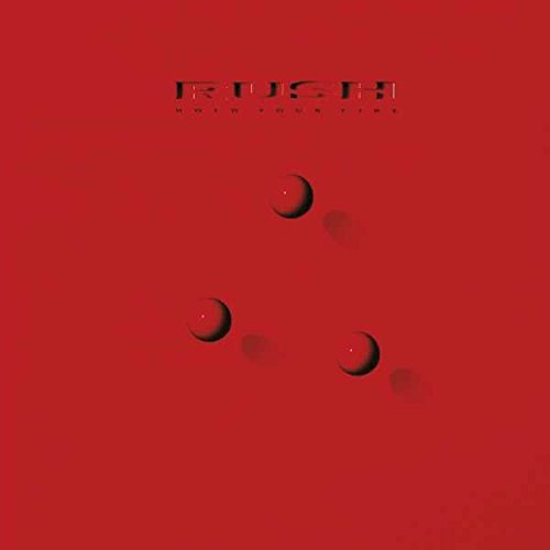 Red vinyl album cover with "RUSH" and "HOLD YOUR FIRE" text, featuring three crescent shapes.