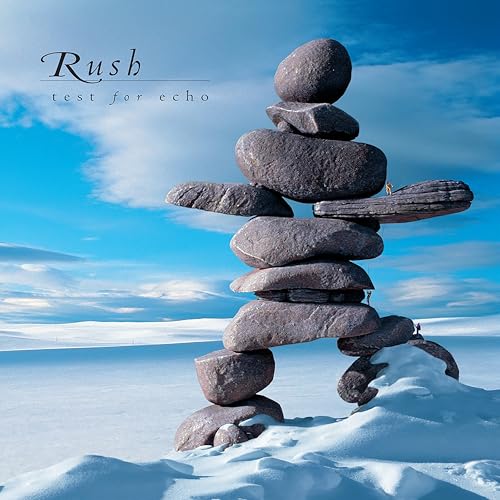Album cover: stacked rocks in a snowy landscape under a blue sky.