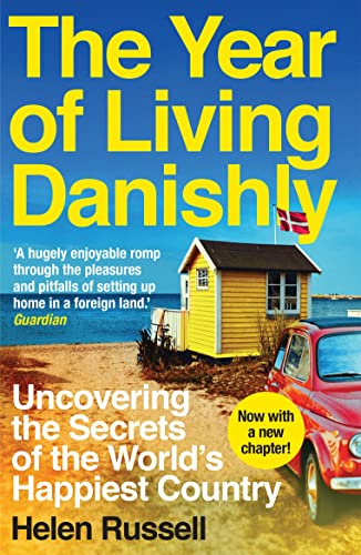 Book cover showing a yellow beach hut, red car, and Danish flag by sea.
