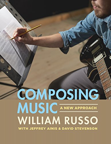 A musician writes on sheet music while holding an electric guitar.