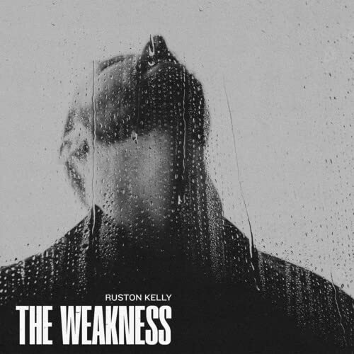 Black and white album cover featuring a blurred face behind rain-streaked glass.