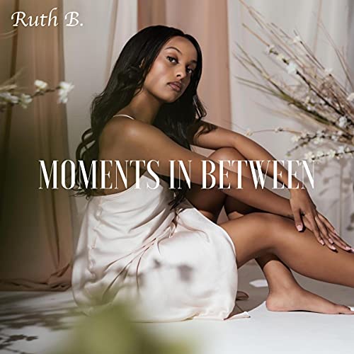 Ruth B. album cover, "Moments In Between," featuring a seated woman.