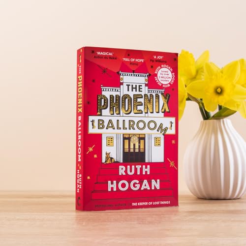 Red book cover with building illustration, daffodils in a white vase.