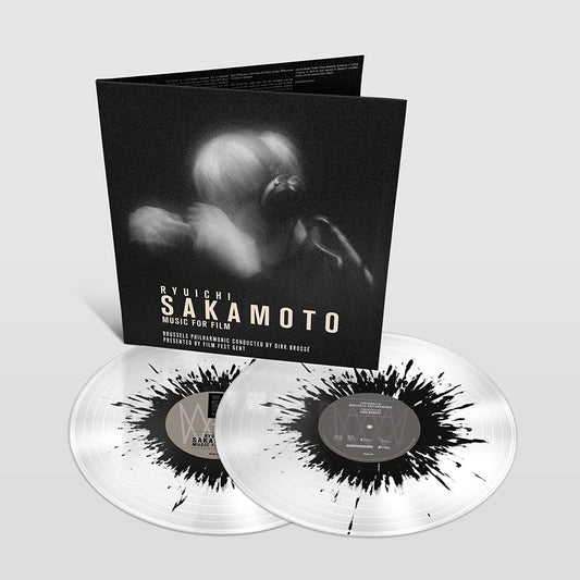 "Clear vinyl records with black splatter and album cover featuring a black and white image."