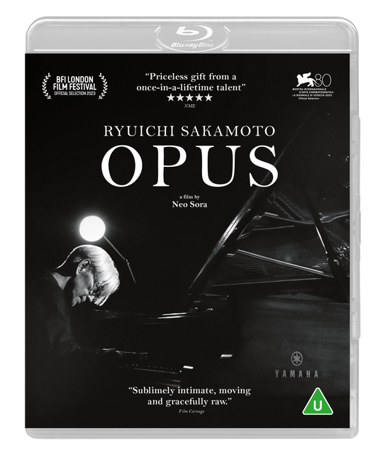 Black and white Blu-ray cover featuring Ryuichi Sakamoto playing a Yamaha grand piano.