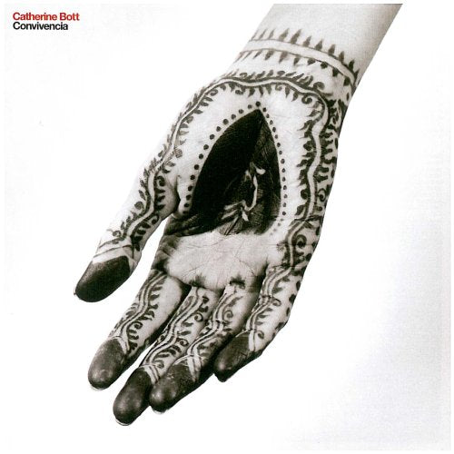 Black and white image of a hand decorated with intricate henna patterns.