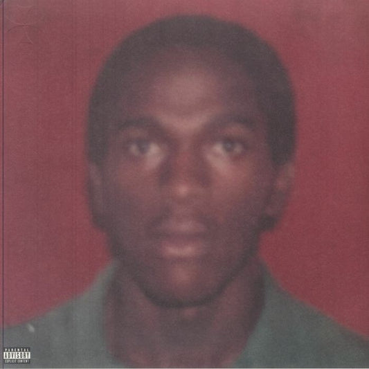 Close-up portrait of Daniel Caesar against a red background, vinyl record.