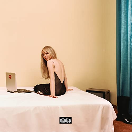 Sabrina Carpenter album cover: woman in black dress on a bed.
