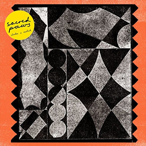 Album cover for Sacred Paws' "Strike A Match" with abstract black and white design.
