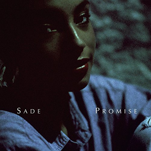 Close-up of Sade Adu, album cover for "Promise" with text.