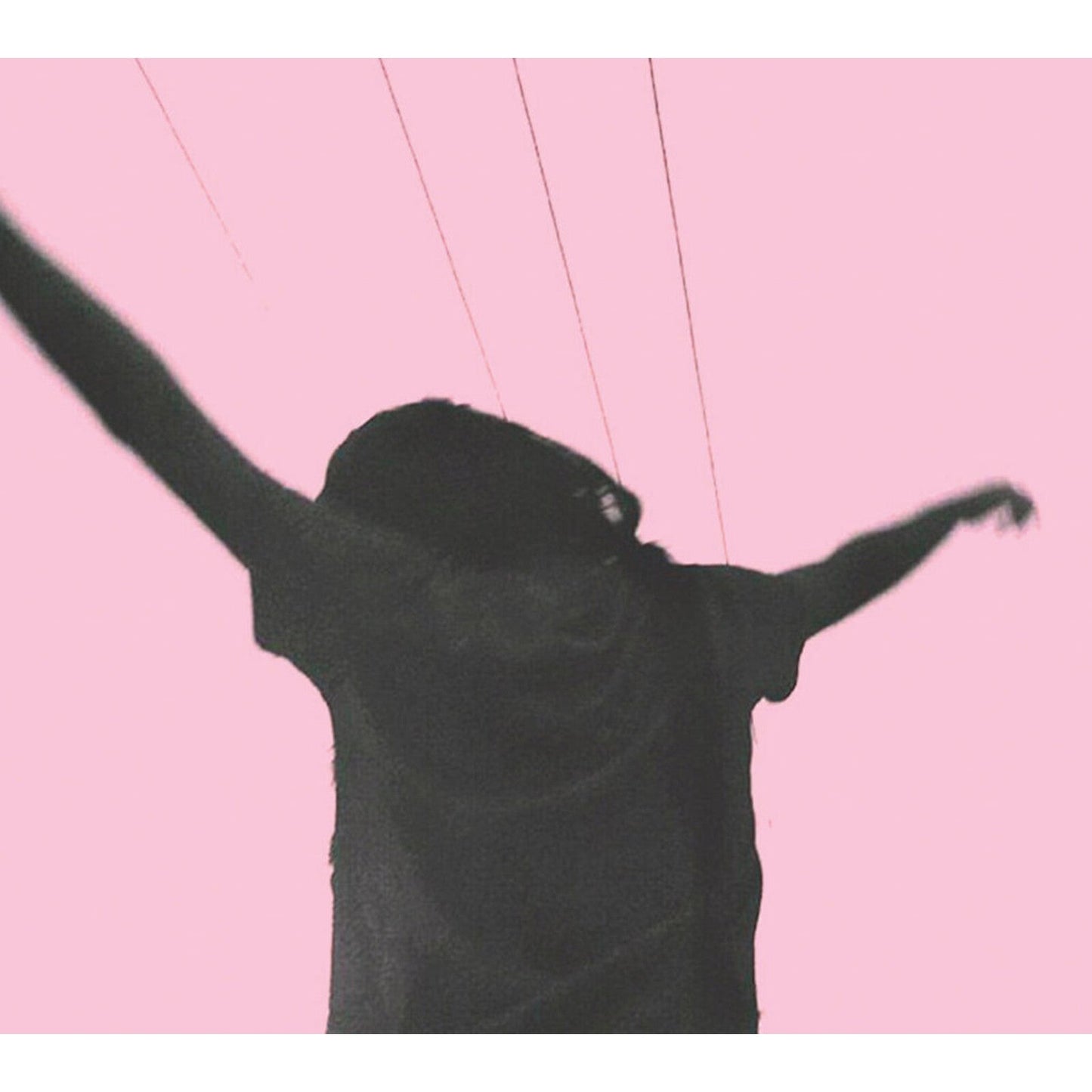 A silhouette of a person with arms outstretched against a solid pink background.