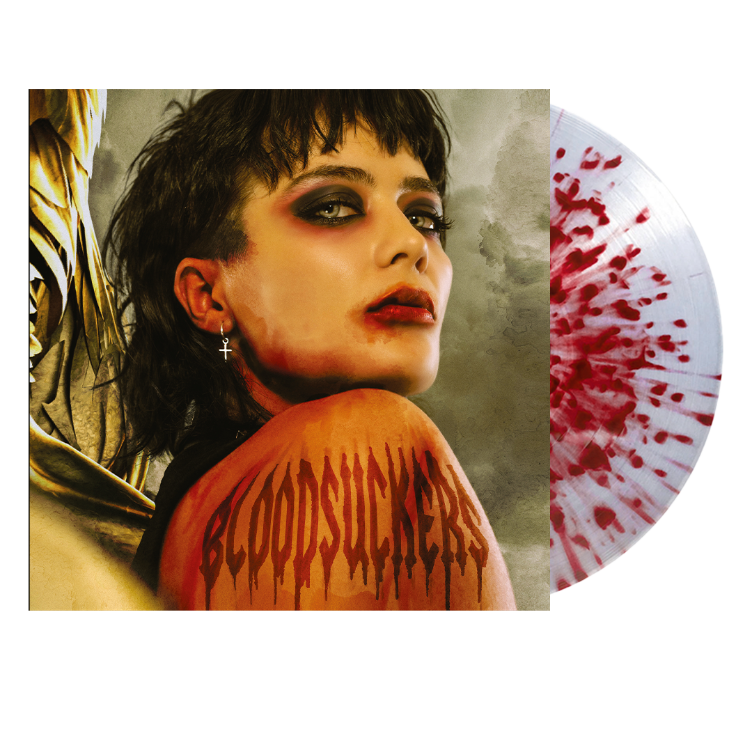 Vinyl record with red splatter design and album cover featuring a woman.