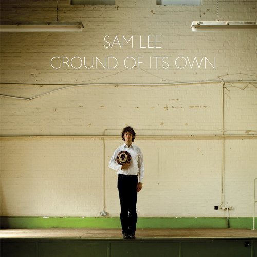 Album cover: Sam Lee stands on a wooden stage, holding flowers.