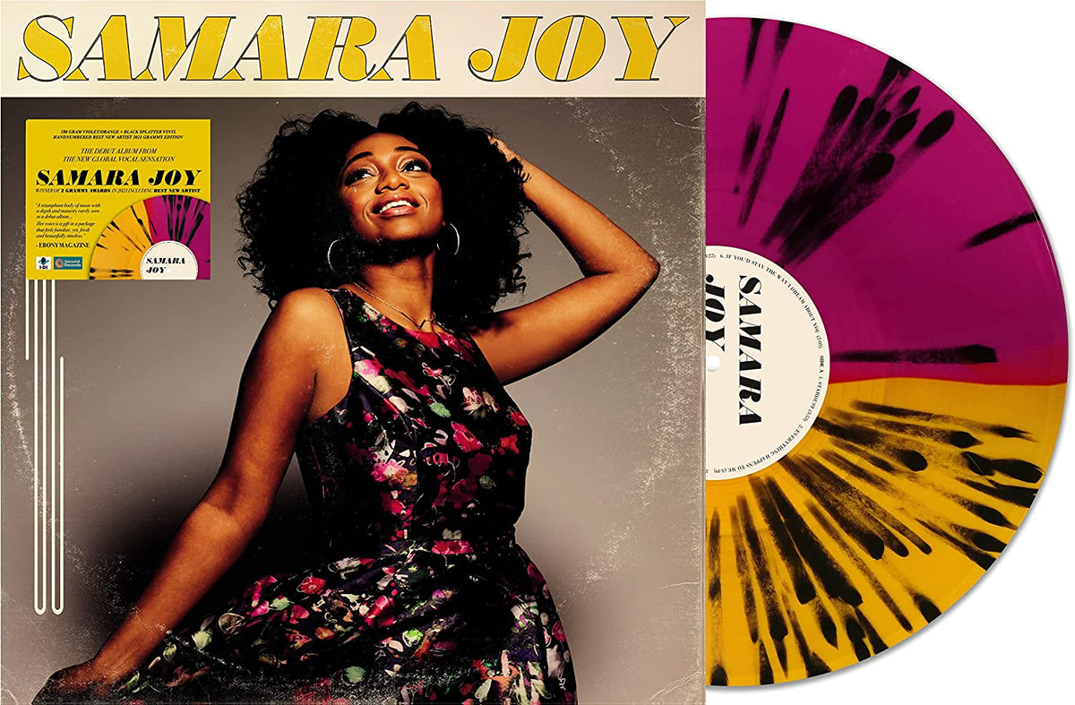 "Vinyl record with pink and yellow splatter design, album cover featuring a smiling woman."