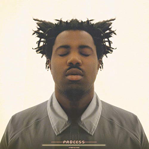 Sampha album cover: close-up of a man with dreadlocks, eyes closed.