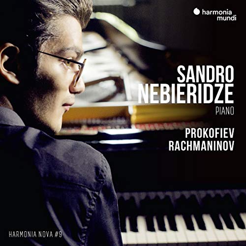 Man in glasses sits at piano with white text overlay on dark background.