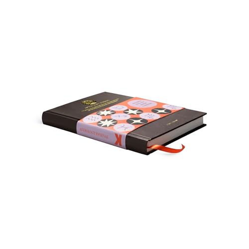 Closed dark-covered astrology journal with a patterned band and red ribbon.