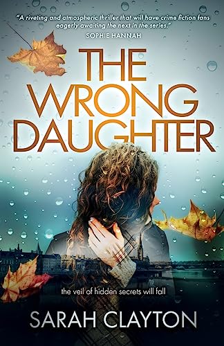 Book cover: woman’s face obscured with city skyline and falling leaves.