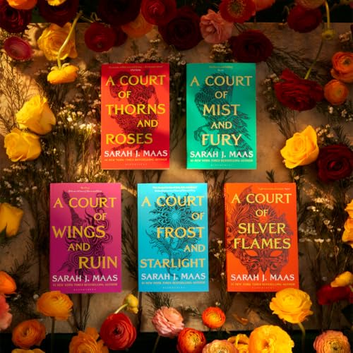 Five paperback books from “A Court of Thorns and Roses” series with flowers.