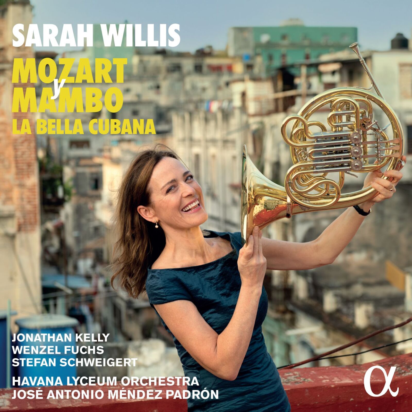 Sarah Willis with a French horn, Havana cityscape background.