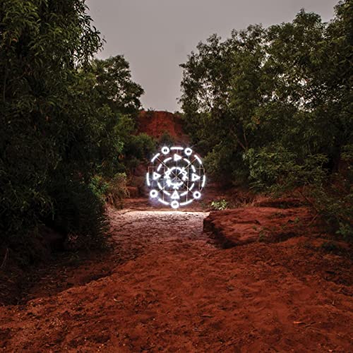 Album cover with a glowing circular symbol in a forest setting.